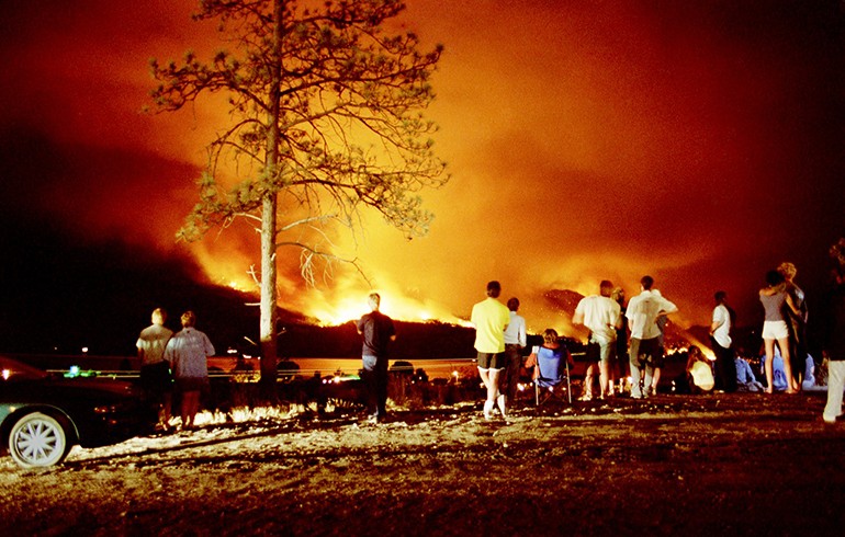 A group of residents watching the 2003 Okanagan Mountain Park fire rages out of control